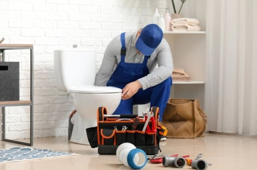 plumber installing a toilet
