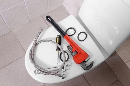 plumbing tools above toilet cover