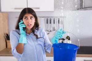 woman calling a plumber to fix water leaks